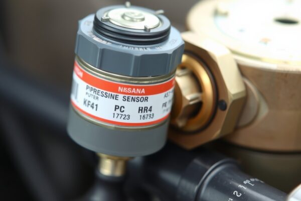 Close-up view of a Nissan K24 propane pressure sensor mounted on a vehicle’s fuel system